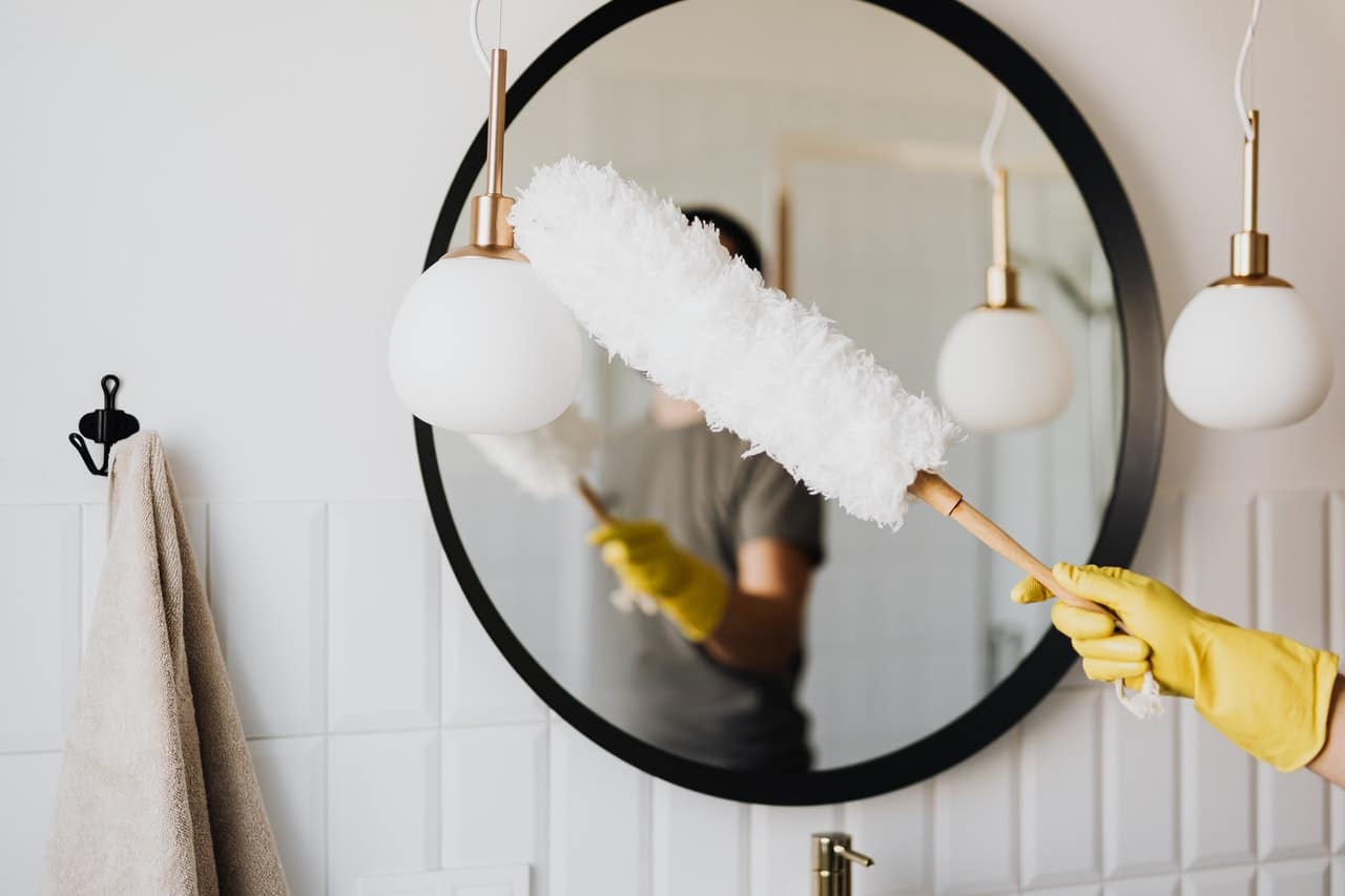 Woman dusting her home