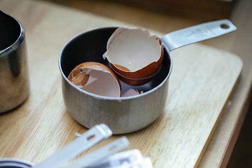 broken boiled egg shells in pan